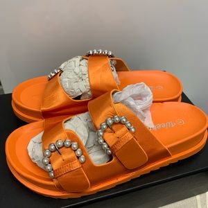 Orange sandals. new pair soft material